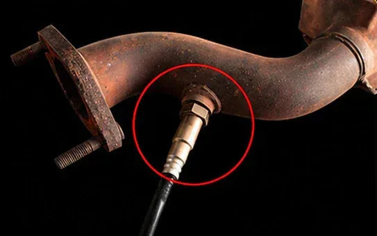 Oxygen sensor spacer installation step showing sensor location on exhaust pipe